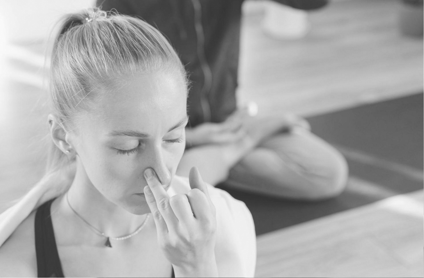Home yoga session in a bright living space showing a practitioner in a grounded pose